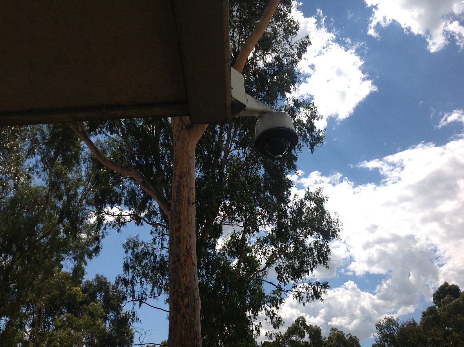 Outdoor security camera under an exterior eave