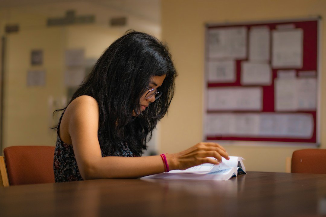 Student studying at a library table